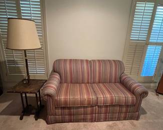 Striped love seat and bamboo floor lamp