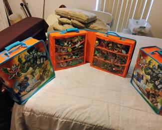 Lots of Skylander action figures in storage boxes