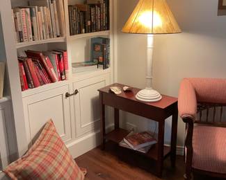 Books, lamp, side table, large oyster shells.
