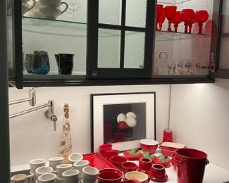 White ramekin sets, ceramic measuring cups, red ceramic pieces, red glassware