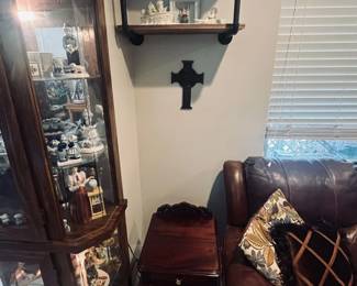 Curio with collectible figurines, shelving unit, side table