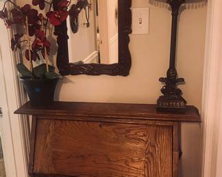 Antique desk, lamp, mirror, flower arrangement