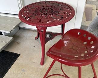 Red plastic table
Iron tractor seat stool