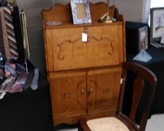 Stately oak drop front desk, cane bottom side chair.