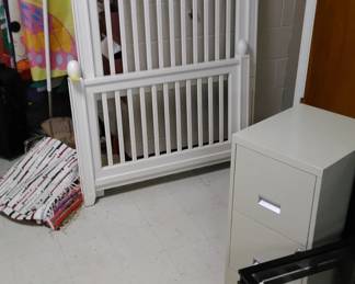 White twin bed, 2 drawer metal fining cabinet.