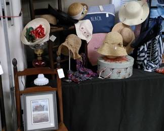 There are seven of these ladder back chairs with rush bottom seats, Great selection of ladies hats, scarves, etc.