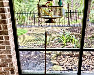 Whimsical brass bird cage on stand