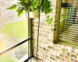Greenery in tall metal plant stand