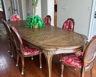 dining table with 6 cane seats (fabric cushion backs can be removed) 9’6” with two 22” leaves in place