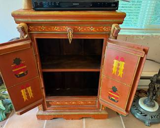 Ornate Wood Cabinet Featuring Stylized Deity Artwork