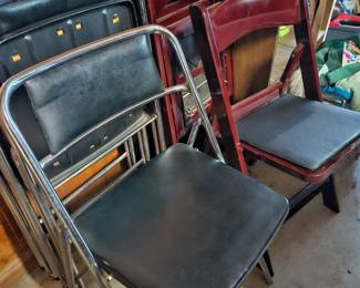 4 black folding chairs. Four wood chairs