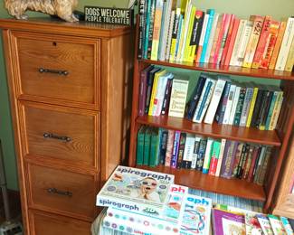 More books and a nice wood file cabinet guarded by a ferocious hound
