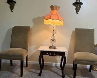 A pair of Parson chairs to sit anywhere in your house with a pair of chandelier lamps  and a set of marble and wood end tables