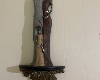 A pair of exquisite Liquid silver African figurines sitting on wall sconces!!