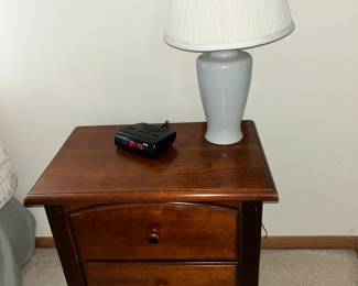 A two drawer end table and a lamp. Violent criminal