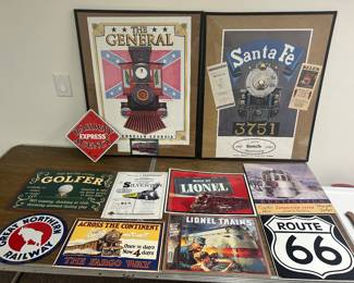 A variety of metal signs depicting railroad, golf, Route 66 and two railroad posters in the background.