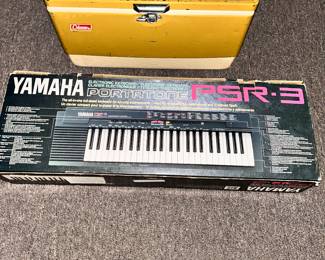 Vintage Coleman cooler and a Yamaha PSR-3 electric keyboard.