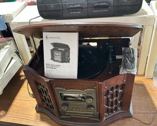 IT phonograph, radio, cassette player with remote. On top is a Sanyo radio/dual cassette player.