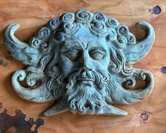 bronze wall mask of Poseidon