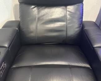 #56 - $400 - Black leather theater recliner with all kind of gadgets & lights effect. Client kept the protective cover on. (approx 2 years old) Mint condition