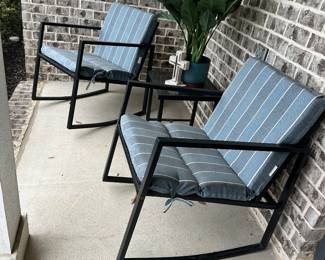 #64 - $120 - 2- black metal patio chairs with blue & dark blue stiped cushions - with glass top table