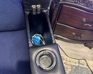 #56 - $400 - Black leather theater recliner with all kind of gadgets & lights effect. Client kept the protective cover on. (approx 2 years old) Mint condition