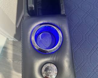 #56 - $400 - Black leather theater recliner with all kind of gadgets & lights effect. Client kept the protective cover on. (approx 2 years old) Mint condition