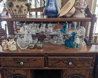 Lots of collectible glass and a very nice side board that matches the table