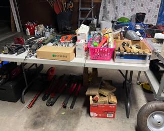 garage full of tools and lawn equipment