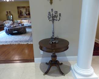 Pair of small round tables, pair of candelabras