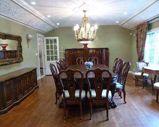 Large ornate antique dining table with 12 chairs