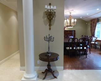 Pair of bronze sconces, pair of small round tables, pair of candelabras