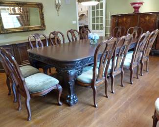 Large ornate antique dining table with 12 chairs