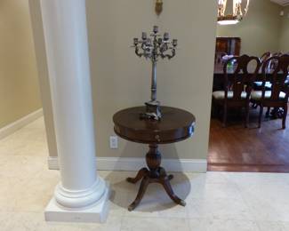 Pair of small round tables, pair of candelabras