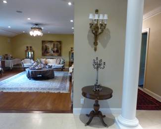 Pair of bronze sconces, pair of small round tables, pair of candelabras