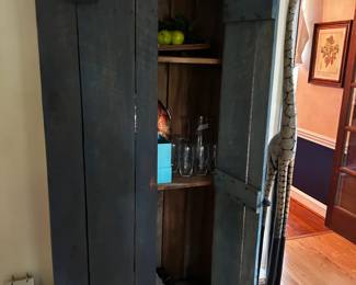 Rustic teal blue painted wood storage cabinet with art glass collection