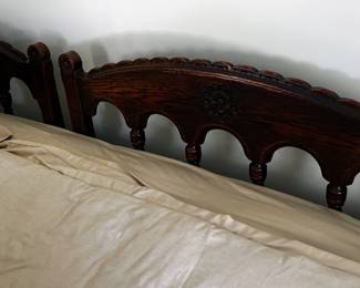 Pair of matching dark carved oak twin bedframes ( now used as a King bed- mattress sold seperately)