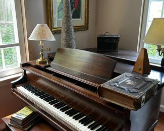 Baby grand piano, vintage English Bible, sheet music