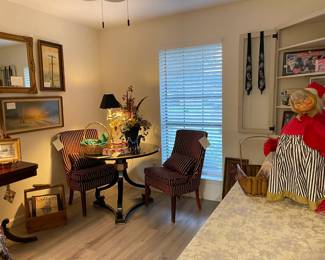 This room contains, beautiful art signed by the artists, burgundy and gold upholstered chairs, round black and gold lacquer table, and a large Lucille Ball collection