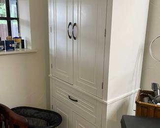 White storage cupboard in the Master bathroom