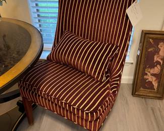One of two burgundy and gold upholstered accent chairs