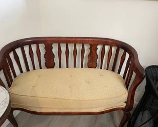 Antique mahogany Settee with upholstered cushion, can also be found in the Master Bedroom
