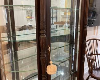 Looking at the display cabinet showing the glass shelves and mirror back