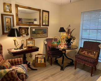 This room, antique game table, round lacquer table, burgundy and gold accent chairs, great art