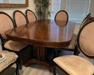 Dining Table with two leaves and protective pads and 8 dining chairs. The table is 120" long with leaves installed and 47" wide. The leaves measure 20" wide.