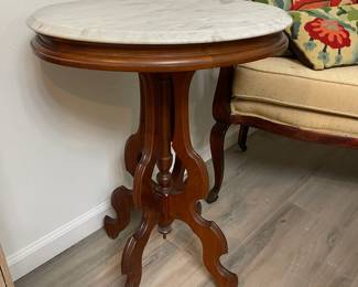 Victorian side table can be found in the Master bathroom