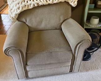 . . . grey upholstered accent chair and cozy afghan