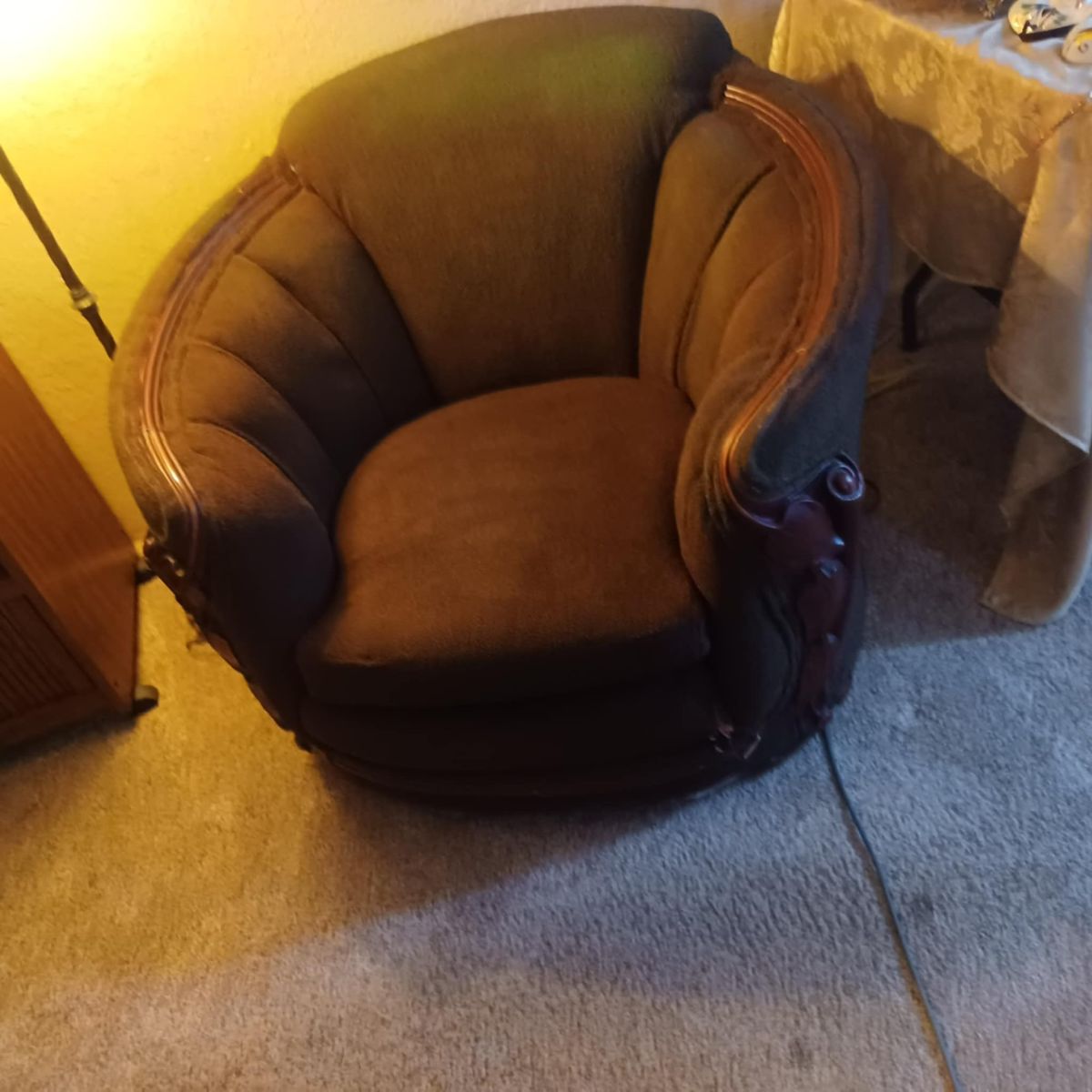 Barrel chair. Neat wood trim.
