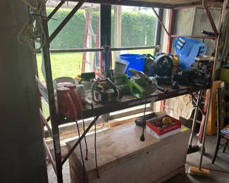 Hedge trimmers , chainsaws, trunk 2 sections of baker scaffolding w/outriggers