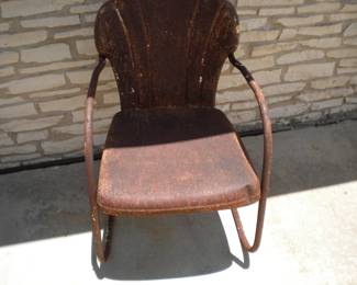 One of several various metal lawn chairs